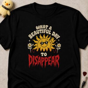 Black t-shirt printed WHAT A BEAUTIFUL DAY TO DISAPPEAR around a smiling sun in sunglasses, DISAPPEAR in red metal lettering
