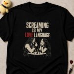 Black t-shirt printed SCREAMING IS MY LOVE LANGUAGE above a man screaming into a microphone at a candlelit dinner while his date smiles