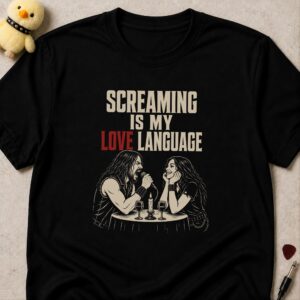 Black t-shirt printed SCREAMING IS MY LOVE LANGUAGE above a man screaming into a microphone at a candlelit dinner while his date smiles