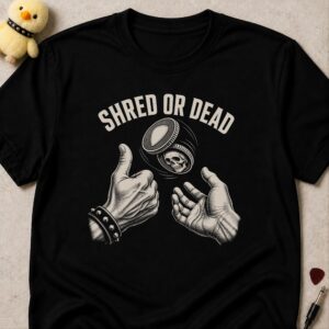 Black t-shirt printed SHRED OR DEAD above two hands flipping a coin with a skull on one face