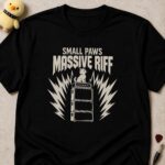 Black t-shirt printed SMALL PAWS MASSIVE RIFF above a kitten sitting on top of an amplifier stack