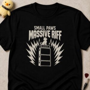 Black t-shirt printed SMALL PAWS MASSIVE RIFF above a kitten sitting on top of an amplifier stack
