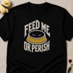 Black t-shirt printed FEED ME OR PERISH around a pet bowl with glowing purple eyes inside it