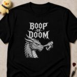 Black t-shirt printed BOOP OF DOOM above an armoured gauntlet booping a dragon on the snout