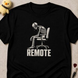 Black t-shirt printed REMOTE below a skeleton slumped in an office chair wearing headphones
