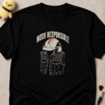 Black t-shirt printed MOSH RESPONSIBLE above a white hard hat and ear defenders over a studded denim battle vest