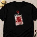 Black t-shirt printed with a laminated event pass reading PROFESSIONAL HEADBANGER over flying red hair