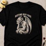 Black t-shirt printed RESTING RIFF FACE above a scowling gargoyle sitting with earphones in