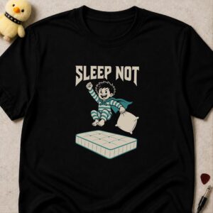 Black t-shirt printed SLEEP NOT above a caped child in pyjamas leaping off a mattress with a pillow