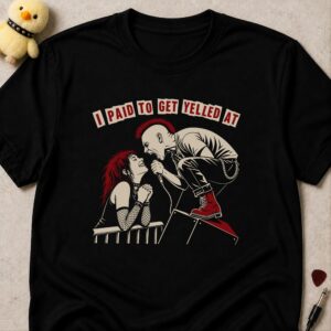 Black t-shirt printed I PAID TO GET YELLED AT above a singer leaning off stage screaming at a grinning fan at the barrier