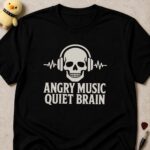 Black t-shirt printed ANGRY MUSIC QUIET BRAIN under a skull wearing headphones between two heartbeat lines