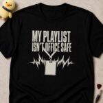 Black t-shirt printed MY PLAYLIST ISN'T OFFICE SAFE above an office lanyard badge throwing off lightning bolts