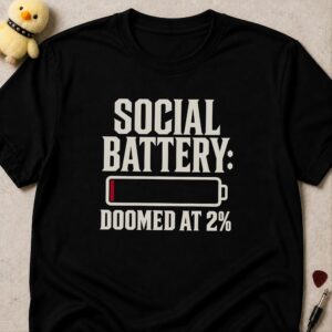 Black t-shirt printed SOCIAL BATTERY: DOOMED AT 2% around an almost empty battery icon with a red sliver