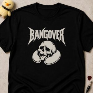 Black t-shirt printed BANGOVER in spiky metal lettering above a tired skull resting on a neck pillow with its tongue out