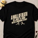 Black t-shirt printed A WALL OF DEATH IS JUST A HUG WITH A RUNNING START in cream slanted lettering above two running stick figures